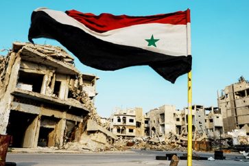 Syrian flag flutters at a military check point in al-Khalidiya area, in the government-controlled part of Homs, Syria, September 18, 2018. REUTERS/Marko Djurica